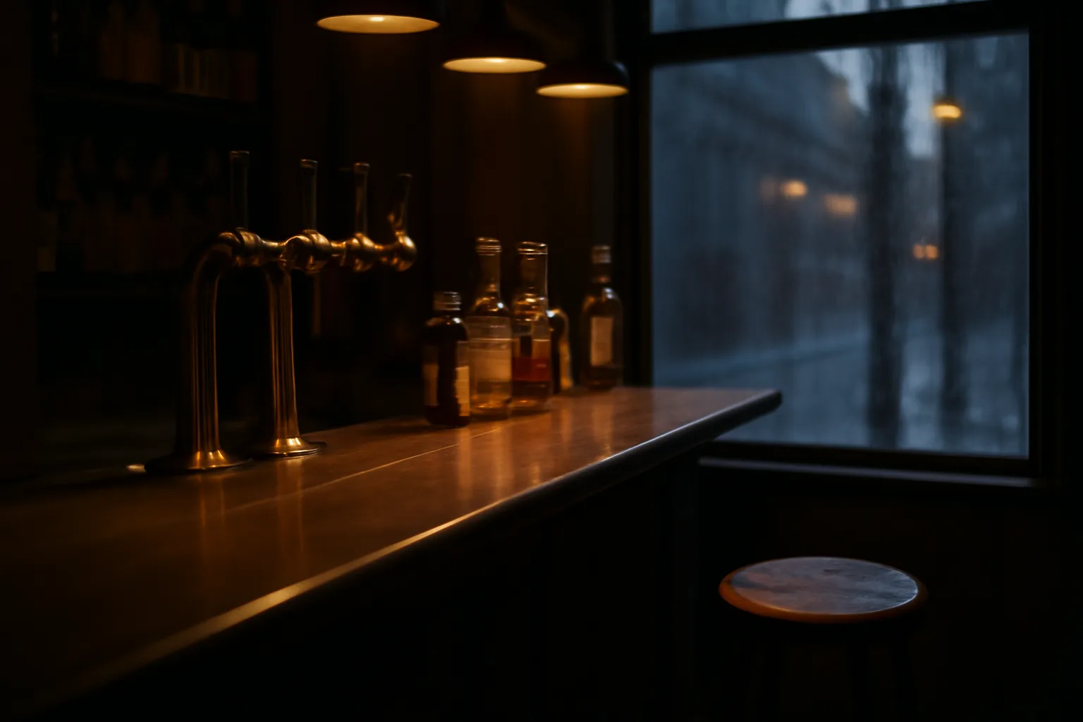 Empty bar counter with beer taps lit at dusk, representing an ABC beer license setting