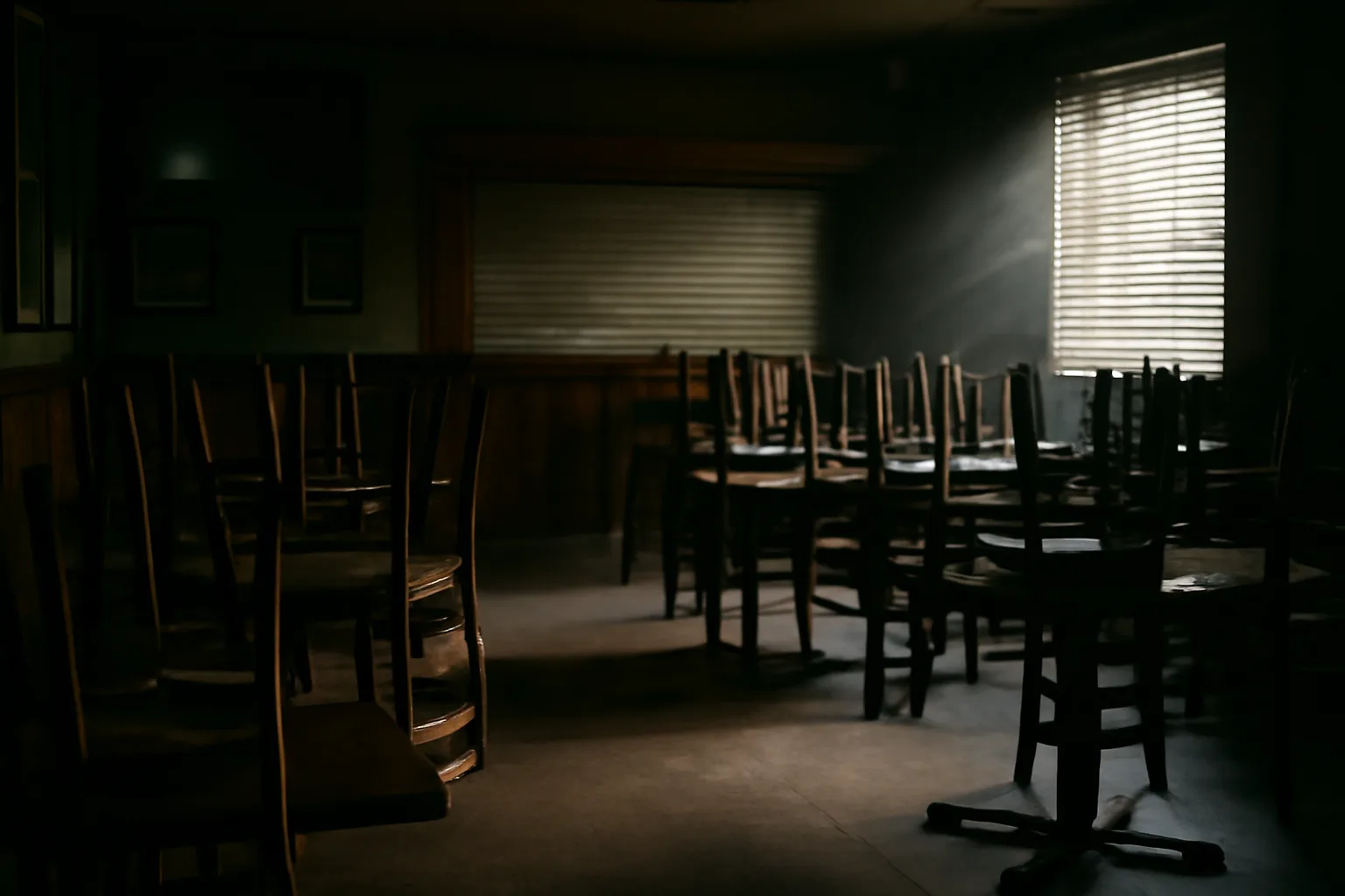 Empty sports bar with stacked chairs during a liquor license suspension closure